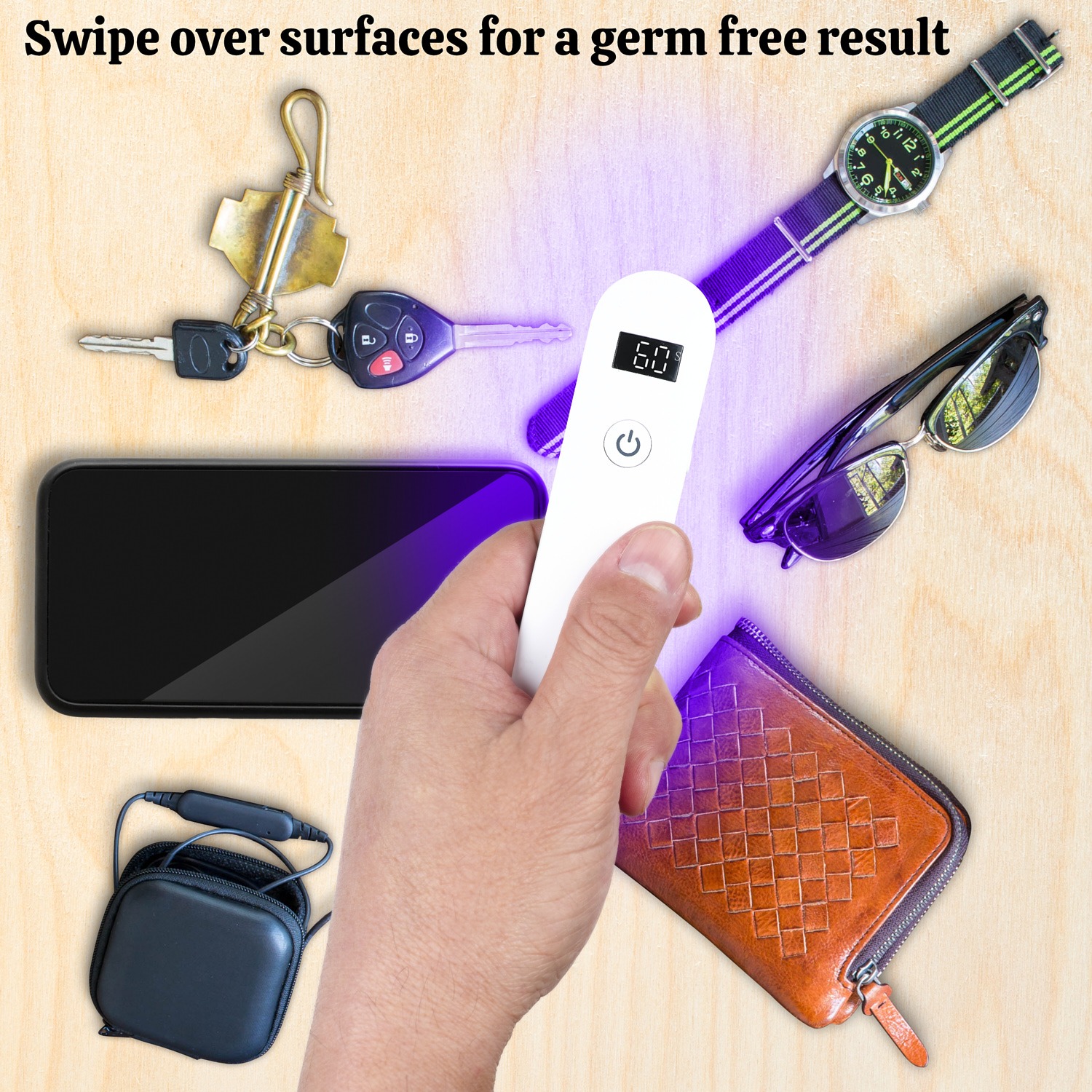 Sanitising keys, phone, watch, wallet and sunglasses on a wood surface